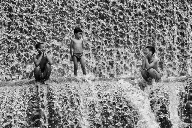 Boys playing on Unda River, Bali